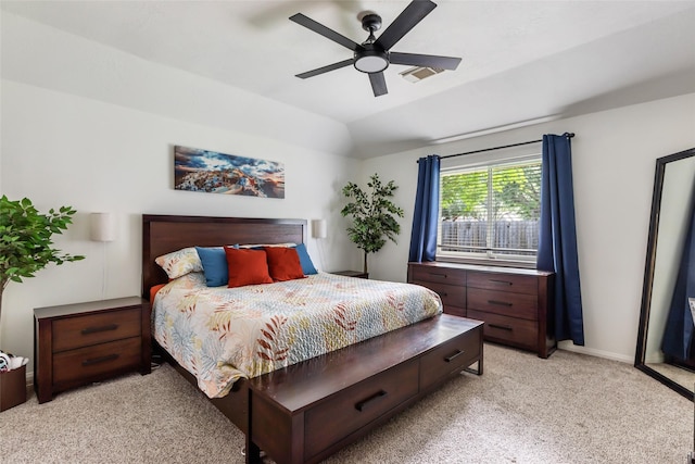 bedroom featuring light colored carpet, a ceiling fan, and baseboards