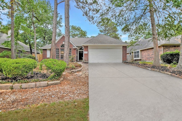 67 N Winterport Cir, The Woodlands, TX 77382 - view of front of house with a garage, brick siding, concrete driveway, and roof with shingles