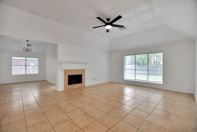 67 N Winterport Cir, The Woodlands, TX 77382 - unfurnished living room with light tile patterned floors, plenty of natural light, a ceiling fan, and a tiled fireplace