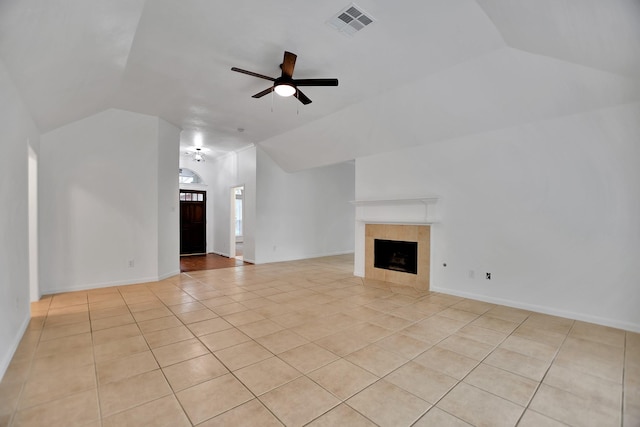 67 N Winterport Cir, The Woodlands, TX 77382 - unfurnished living room featuring vaulted ceiling, light tile patterned floors, ceiling fan, a fireplace, and baseboards