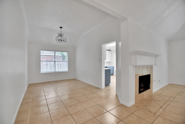 67 N Winterport Cir, The Woodlands, TX 77382 - unfurnished living room featuring vaulted ceiling, light tile patterned flooring, a tile fireplace, and baseboards