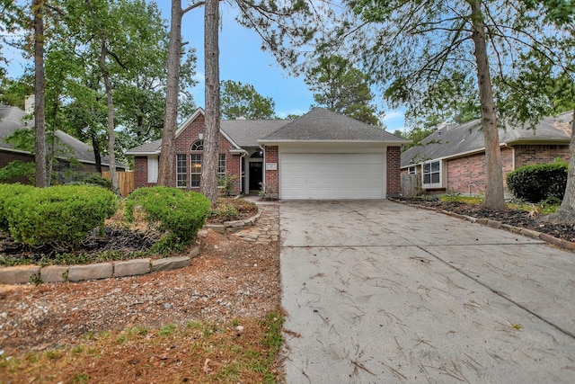 67 N Winterport Cir, The Woodlands, TX 77382 - view of front facade with an attached garage, brick siding, and driveway