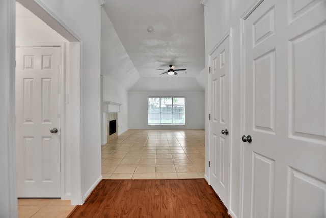 67 N Winterport Cir, The Woodlands, TX 77382 - hallway with tile patterned flooring, vaulted ceiling, and baseboards