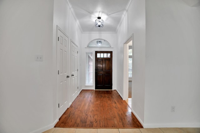 67 N Winterport Cir, The Woodlands, TX 77382 - entryway with ornamental molding, wood finished floors, and baseboards