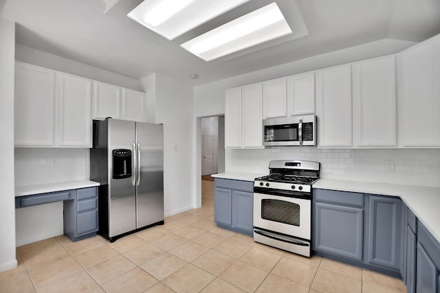 67 N Winterport Cir, The Woodlands, TX 77382 - kitchen with appliances with stainless steel finishes, light countertops, tasteful backsplash, and white cabinetry