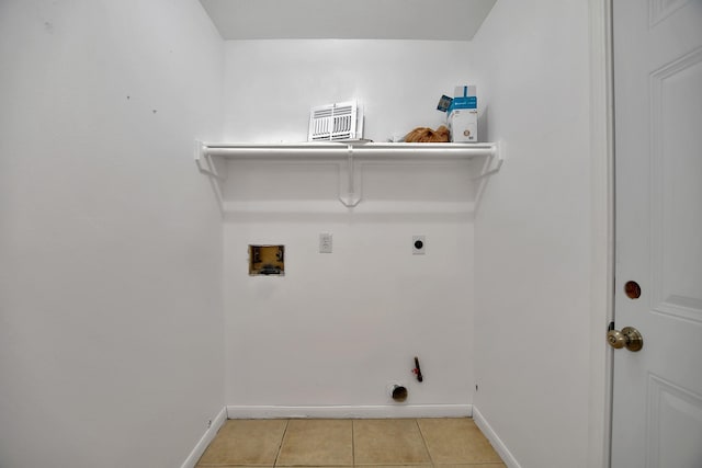 67 N Winterport Cir, The Woodlands, TX 77382 - washroom with hookup for a washing machine, baseboards, light tile patterned floors, hookup for an electric dryer, and gas dryer hookup