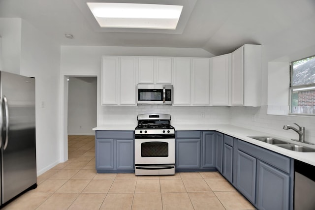 67 N Winterport Cir, The Woodlands, TX 77382 - kitchen with appliances with stainless steel finishes, a sink, tasteful backsplash, light countertops, and lofted ceiling