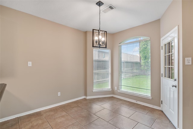 23106 Willow Canyon Dr, Katy, TX 77494 - unfurnished dining area with a chandelier, baseboards, and light tile patterned floors