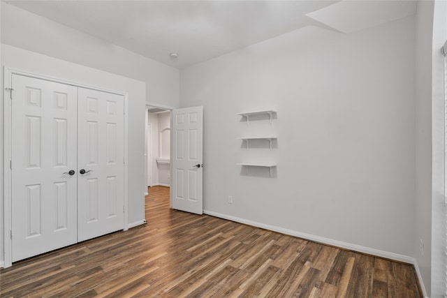 23106 Willow Canyon Dr, Katy, TX 77494 - unfurnished bedroom with dark wood-type flooring, baseboards, and a closet