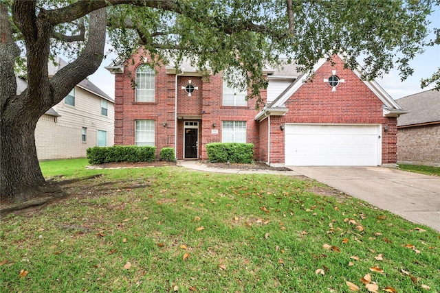 23106 Willow Canyon Dr, Katy, TX 77494 - traditional home with an attached garage, concrete driveway, a front lawn, and brick siding