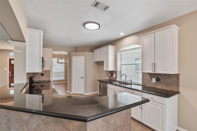 23106 Willow Canyon Dr, Katy, TX 77494 - kitchen featuring a sink, stainless steel appliances, backsplash, a peninsula, and white cabinets