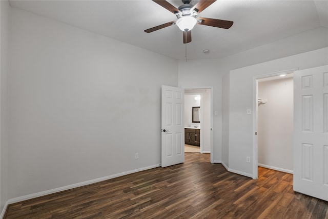 23106 Willow Canyon Dr, Katy, TX 77494 - unfurnished bedroom with dark wood-type flooring, baseboards, a spacious closet, a closet, and a ceiling fan