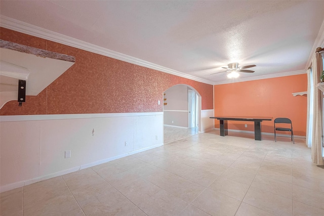 7022 Triola Ln, Houston, TX 77074 - tiled spare room with crown molding, a ceiling fan, arched walkways, and wainscoting