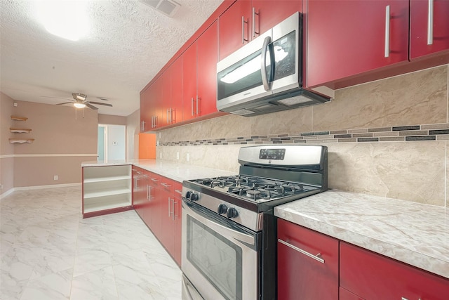 7022 Triola Ln, Houston, TX 77074 - kitchen featuring stainless steel appliances, visible vents, decorative backsplash, and red cabinets