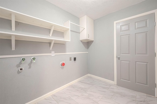 7022 Triola Ln, Houston, TX 77074 - washroom featuring a textured ceiling, marble finish floor, electric dryer hookup, hookup for a gas dryer, and baseboards