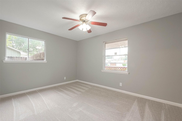 7022 Triola Ln, Houston, TX 77074 - spare room with a textured ceiling, ceiling fan, light carpet, and baseboards