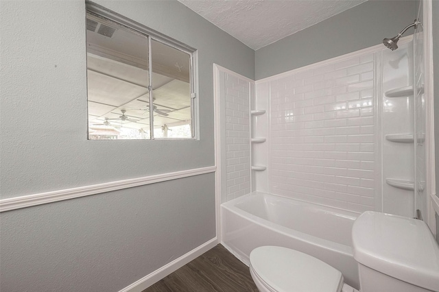 7022 Triola Ln, Houston, TX 77074 - full bath with a textured ceiling, wood finished floors, baseboards, toilet, and bathing tub / shower combination