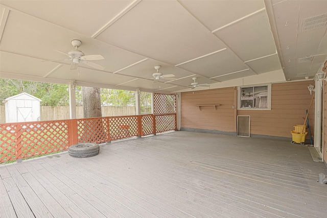 7022 Triola Ln, Houston, TX 77074 - deck with fence, a ceiling fan, an outdoor structure, and a storage unit