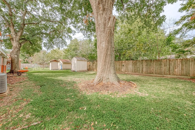 7022 Triola Ln, Houston, TX 77074 - view of yard with a fenced backyard, an outdoor structure, central air condition unit, and a shed