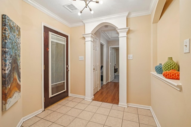 hall featuring visible vents, crown molding, arched walkways, light tile patterned floors, and ornate columns