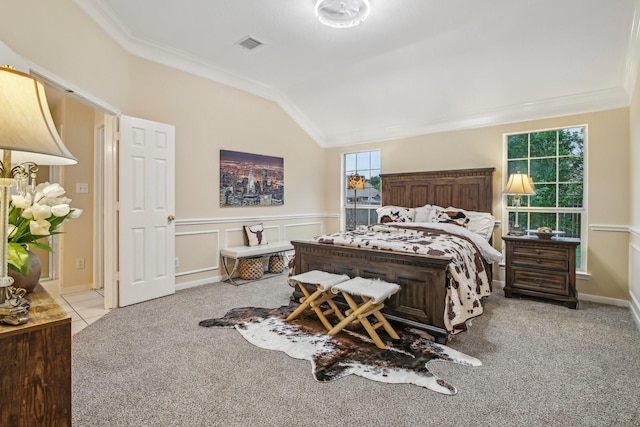 bedroom with carpet flooring, crown molding, visible vents, and lofted ceiling