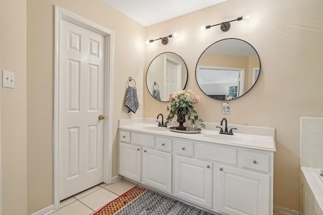 bathroom featuring double vanity, a sink, tile patterned floors, and a tub