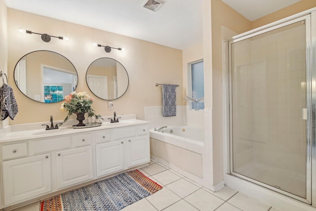 full bathroom featuring a bath, visible vents, a shower stall, a sink, and tile patterned floors
