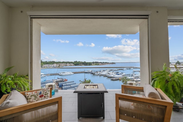 interior space featuring a water view and an outdoor fire pit