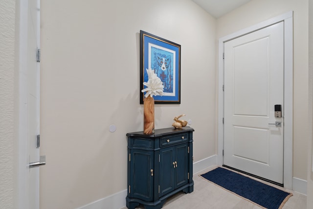 doorway featuring baseboards