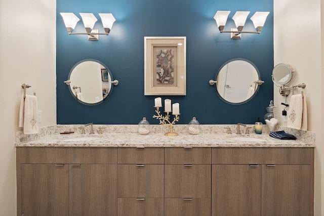 bathroom featuring a sink and double vanity