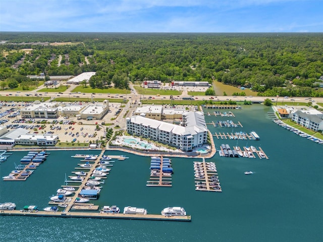 birds eye view of property with a water view and a view of trees