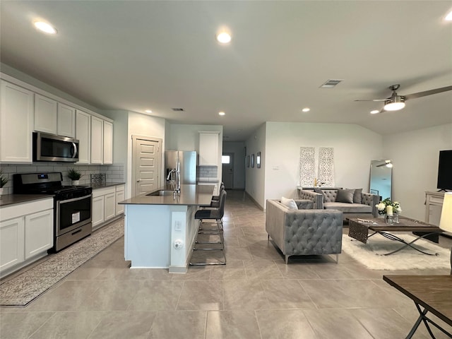 29403 Paytons Park Ct, Katy, TX 77494 - kitchen featuring stainless steel appliances, a ceiling fan, a sink, open floor plan, and tasteful backsplash