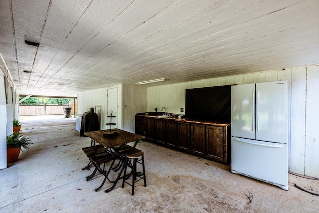 50 Canary St, Point Blank, TX 77364 - miscellaneous room with concrete flooring, wood walls, and a sink