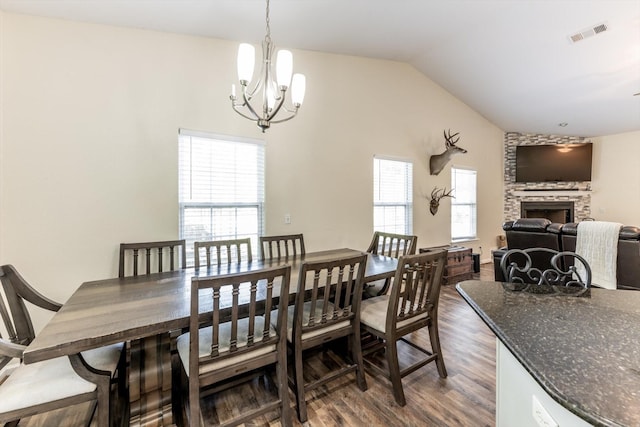 50 Canary St, Point Blank, TX 77364 - dining room with dark wood finished floors, a chandelier, a fireplace, and vaulted ceiling