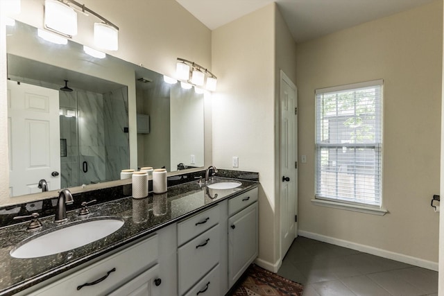 50 Canary St, Point Blank, TX 77364 - bathroom with a stall shower, double vanity, tile patterned floors, and baseboards