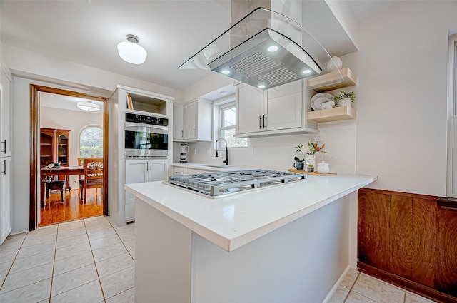 12622 Pine Bough Ln, Cypress, TX 77429 - kitchen featuring island exhaust hood, open shelves, appliances with stainless steel finishes, and a peninsula