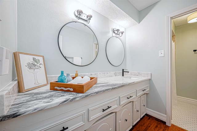 12622 Pine Bough Ln, Cypress, TX 77429 - bathroom featuring vanity, baseboards, a shower with curtain, and wood finished floors