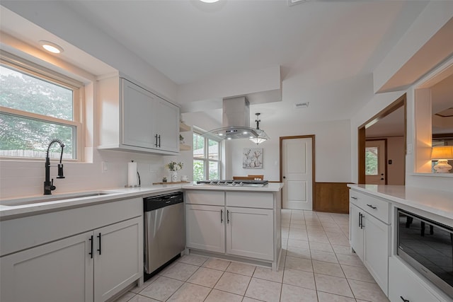 12622 Pine Bough Ln, Cypress, TX 77429 - kitchen featuring a sink, light countertops, stainless steel appliances, a peninsula, and island exhaust hood