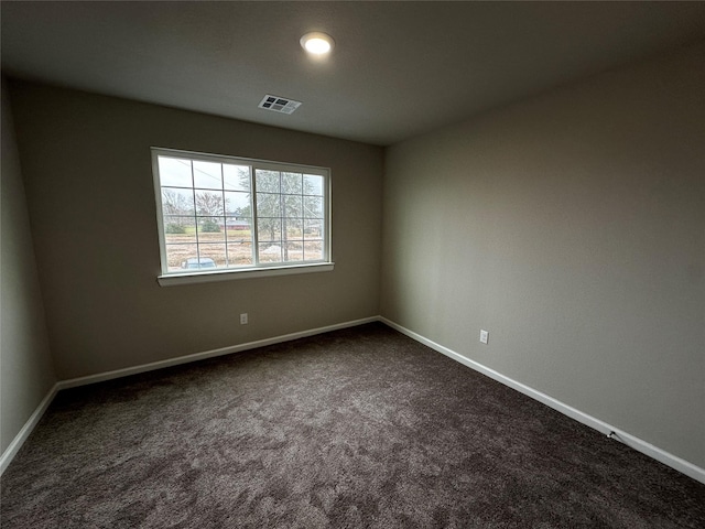 empty room with visible vents, recessed lighting, baseboards, and dark colored carpet