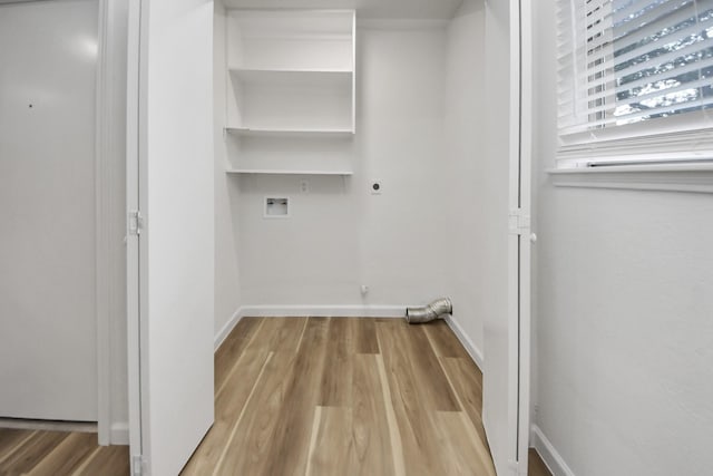 washroom with hookup for an electric dryer, wood finished floors, hookup for a washing machine, and baseboards