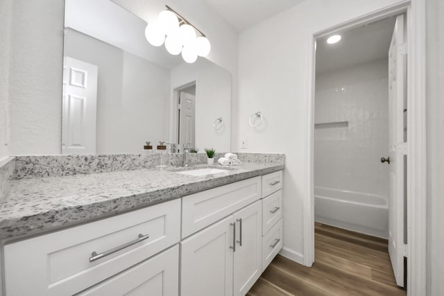 bathroom with wood finished floors and vanity