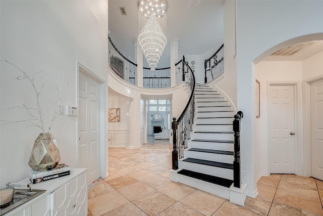 2703 Marble Brook Ln, Pearland, TX 77584 - foyer entrance featuring visible vents, a towering ceiling, arched walkways, stairway, and a notable chandelier