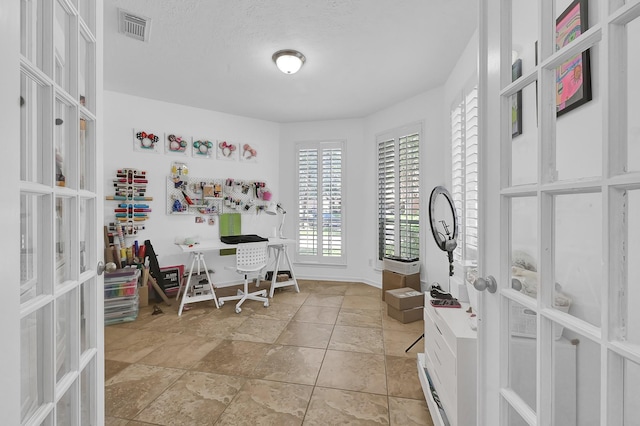 2703 Marble Brook Ln, Pearland, TX 77584 - office with stone tile floors, baseboards, visible vents, and french doors