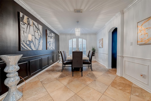 2703 Marble Brook Ln, Pearland, TX 77584 - dining space with visible vents, ornamental molding, a decorative wall, arched walkways, and stone finish flooring