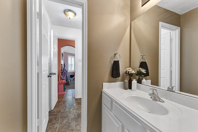2703 Marble Brook Ln, Pearland, TX 77584 - bathroom featuring stone tile flooring, baseboards, and vanity
