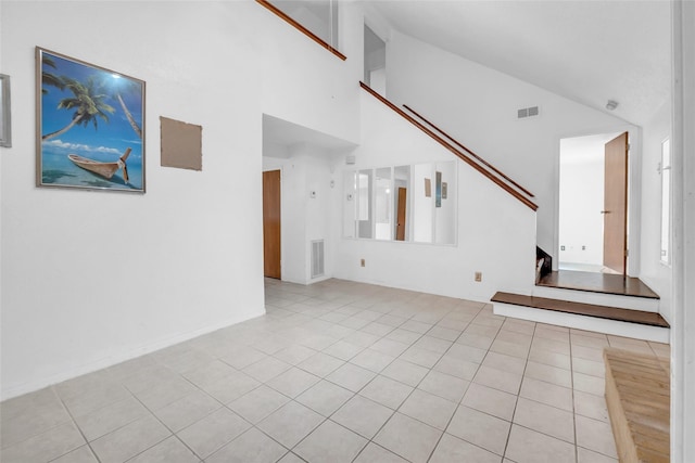 6803 Lakemont Dr, Houston, TX 77050 - unfurnished living room featuring light tile patterned floors, high vaulted ceiling, and visible vents