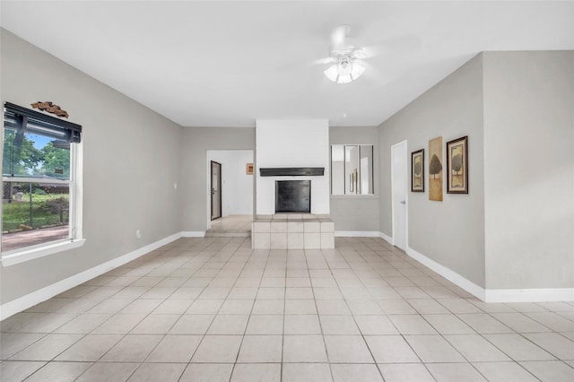 6803 Lakemont Dr, Houston, TX 77050 - unfurnished living room featuring baseboards, a ceiling fan, and a fireplace with raised hearth