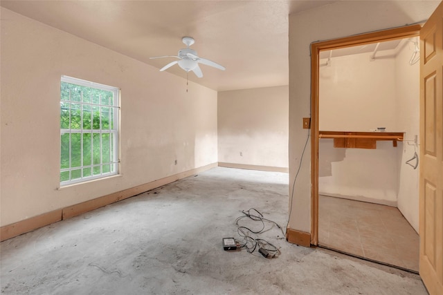 6803 Lakemont Dr, Houston, TX 77050 - interior space with baseboards, a ceiling fan, and concrete floors