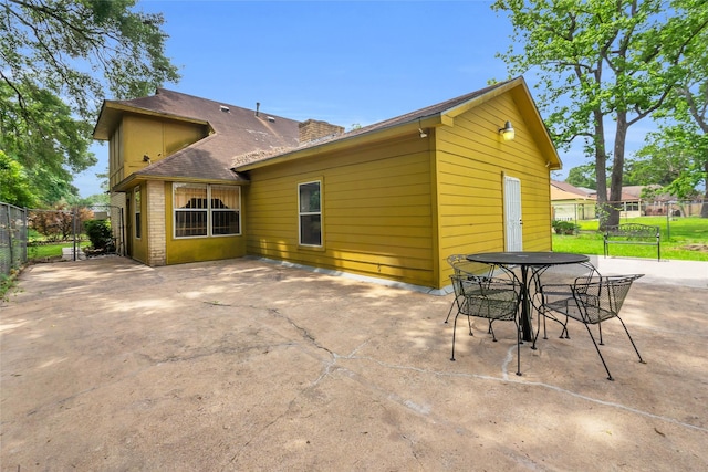 6803 Lakemont Dr, Houston, TX 77050 - rear view of house with a patio, fence, and a chimney