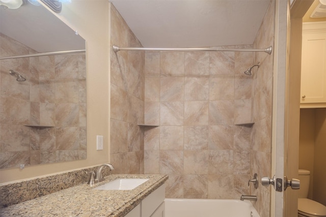 bathroom featuring toilet, vanity, and shower / tub combination